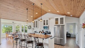 A spacious kitchen with a large island, wooden ceiling, and modern appliances. - Shenandoah mountain view home King bed StarLink EV port river access 90 min DC  (Bentonville)