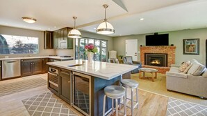 A modern kitchen with a large island, stainless steel appliances, and pendant lighting. - Sonoma Vineyard Estate - 3bd/2bth (Sonoma)