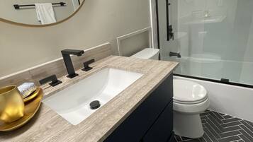 Bañera con ducha, secador de pelo, toallas, jabón