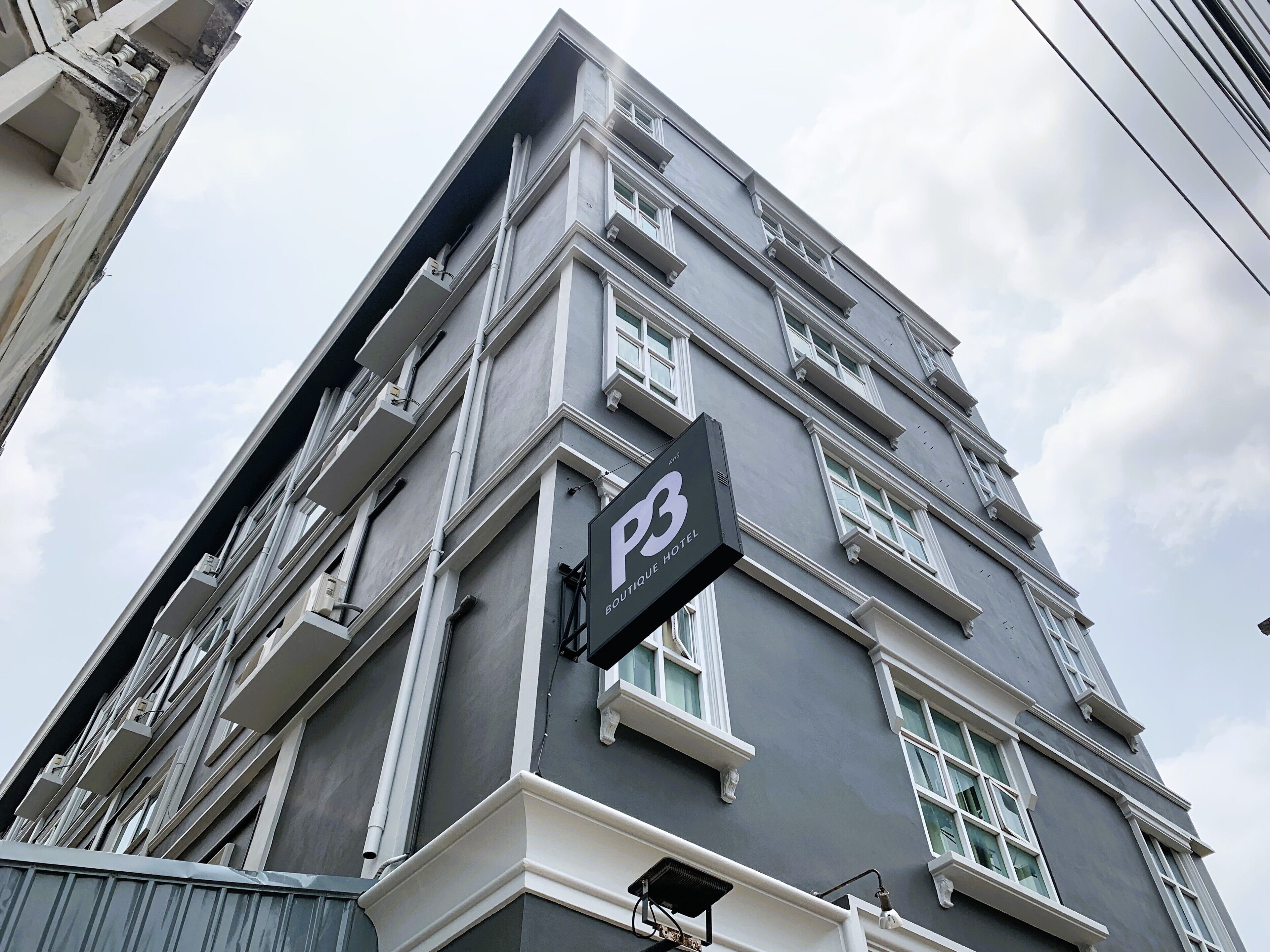 A hotel with a modern facade, featuring a prominent 'P3' sign indicating its name.