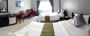 A hotel room with two beds, a desk, a chair, a television, and a window with curtains. - Submukdaphoomplace Hotel (Mukdahan)