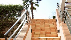 A set of terracotta-tiled stairs with metal railings, leading up to a building entrance. - Exclusive 2 bed  apartment in Vila Sol Village by Experience MamiMi (Quarteira)