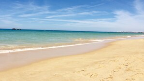 A beach with clear skies and calm waters. - Exclusive 2 bed  apartment in Vila Sol Village by Experience MamiMi (Quarteira)