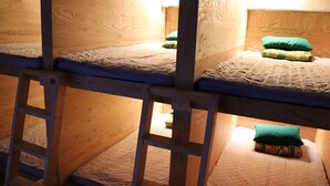 A bunk bed room with wooden walls and a ladder. - gangneung sol guesthouse - Hostel (Gangneung)