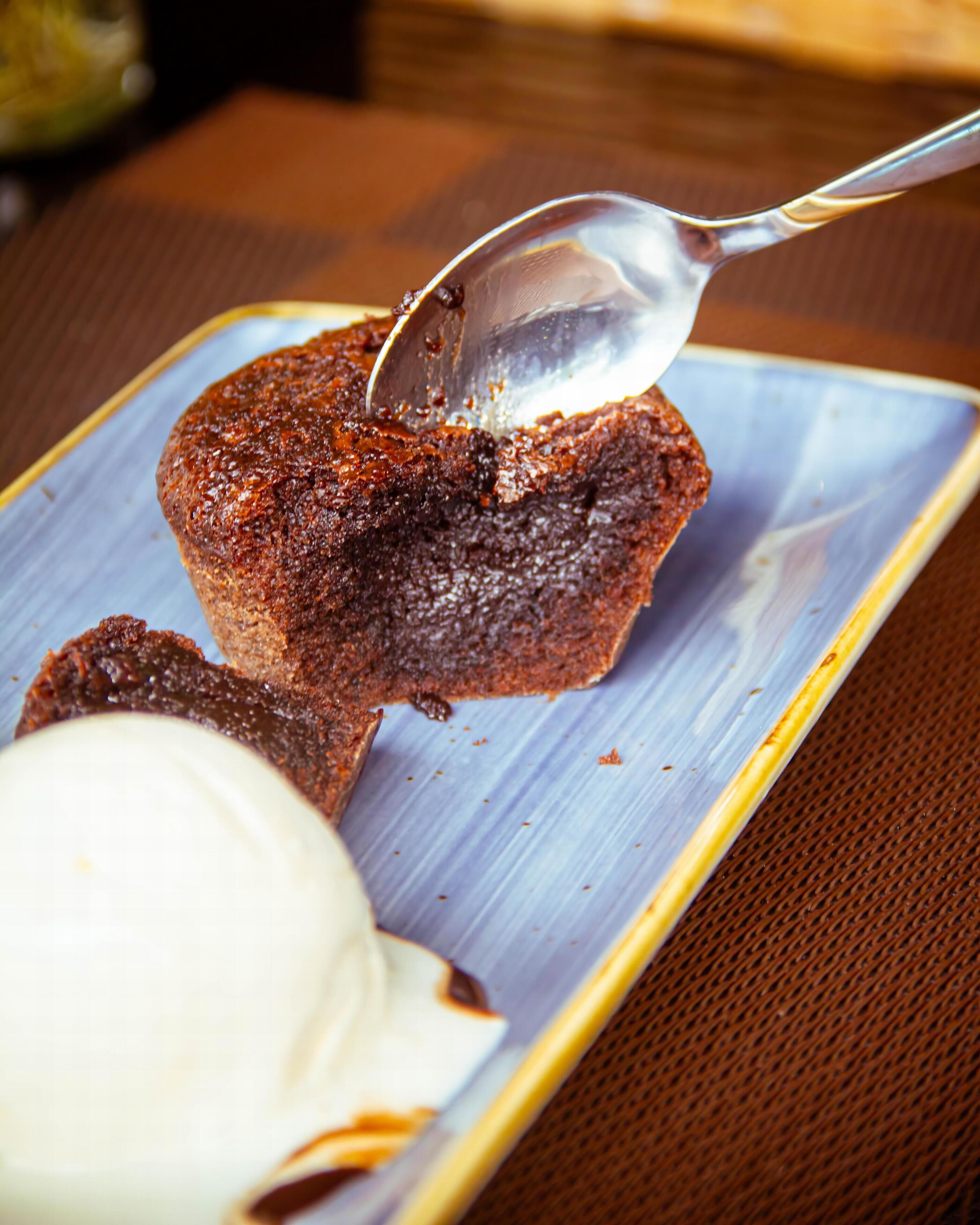 A dessert with a spoonful of sauce on a plate.