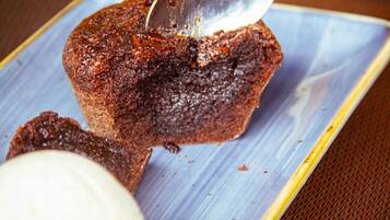 A dessert with a spoonful of sauce on a plate.