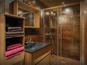 A modern bathroom with a glass-enclosed shower, wooden cabinetry, and a black countertop sink. - Chalet Loisel - alpine holiday 10p with Aravis valley views - OVO Network (St Jean de Sixt)