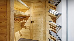 A wooden room with a built-in closet and a rack for hanging clothes. - Chalet Charmar - secluded ski-in ski-out chalet for 12 - OVO Network (La Clusaz)