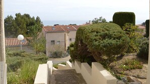 A residential area with a paved pathway leading to a building with a tiled roof. There are neatly trimmed hedges and a spherical light fixture visible. - Studio with mezzanine for 5, near the beach, pets allowed - Saint Pierre la Mer (Fleury-Saint-Pierre-la-Mer)