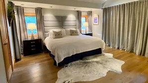 A modern bedroom with a large bed, wooden flooring, and a cowhide rug. - 260+ 10★ Reviews!  Between Vail & Beaver Creek Hot Tub/Fire Table/Ski/Hike/ Golf (Vail)