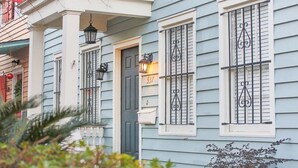 A light blue house with white trim, black window bars, and a number 537 on the door. - Downtown Historic District Gem w/ Courtyard + 3 King Beds by Lucky Savannah (Savannah)