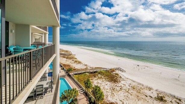 A beachfront hotel with a balcony, pool, and ocean view. - The Oasis at Orange Beach, formerly known as Phoenix West II, Unit 703 (Orange Beach)