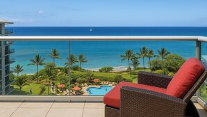 A balcony with a view of the ocean, a pool, and lounge chairs. - Honua Kai | Ocean View 3 BR Sleeps 8 | Car Incl. w/ 6+ Nights | HKH-925 by KBM (Lahaina)