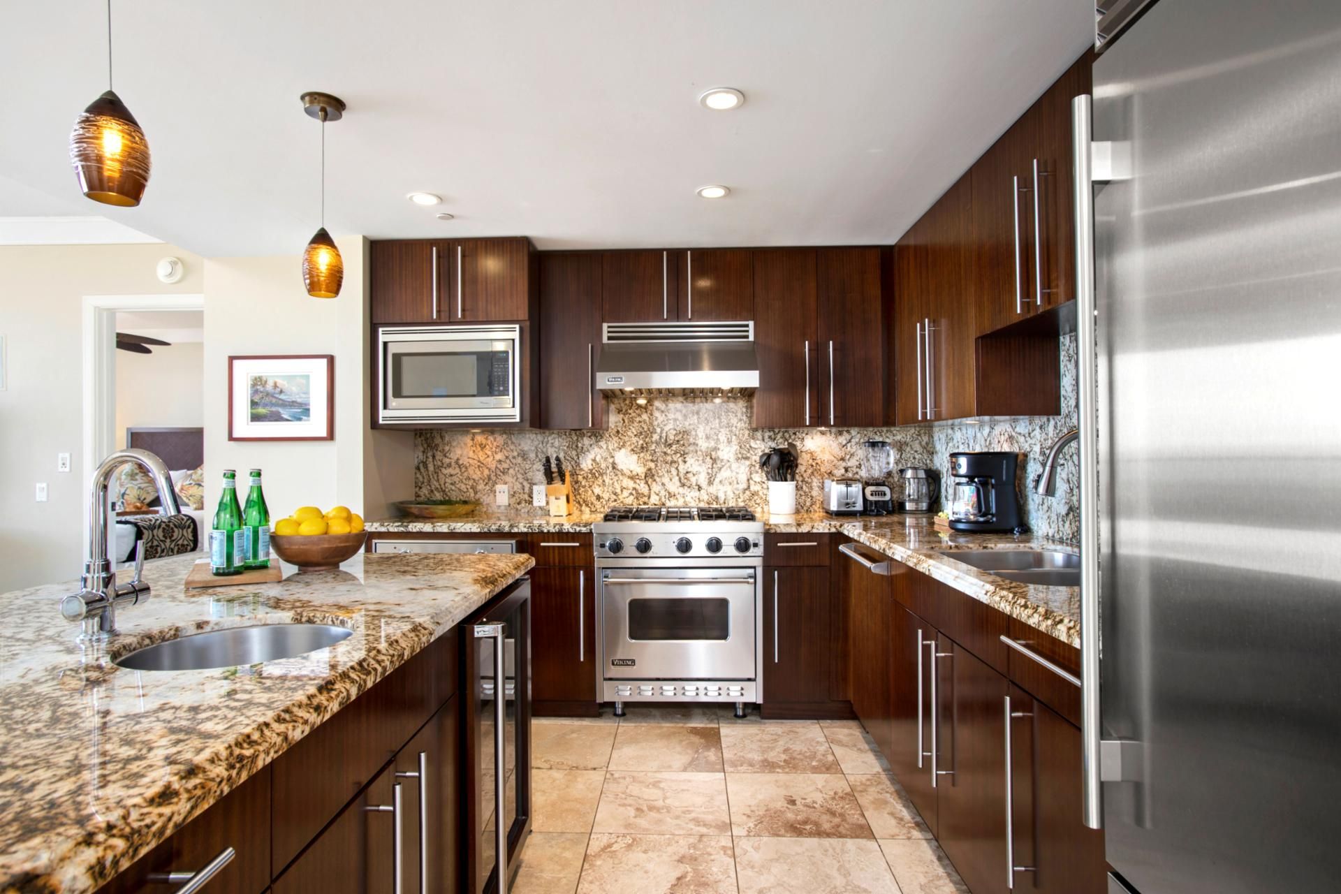 A modern kitchen with granite countertops, stainless steel appliances, and wooden cabinets.