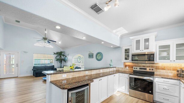 A spacious kitchen with white cabinets, a built-in oven, and a microwave. - Heavenly Sunset...A House With Amazing Views And Just Steps From The Beach (Surfside Beach)