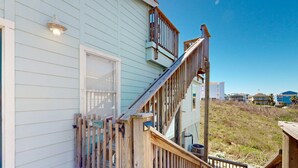 A wooden deck with a staircase leading to a balcony. - LP11 Ocean View from Deck, Boardwalk, Golf Cart Access (Port Aransas)