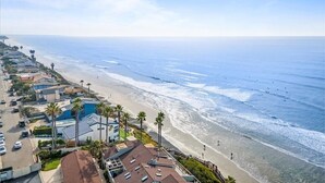 A coastal hotel with a beach view, including a parking area and a pool. - Gorgeous Ocean View Twinhome w/AC! (Encinitas)