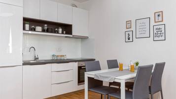 Apartment, 1 Bedroom, Sea View, Sea Facing | Private kitchen | Fridge, stovetop, cleaning supplies, freezer