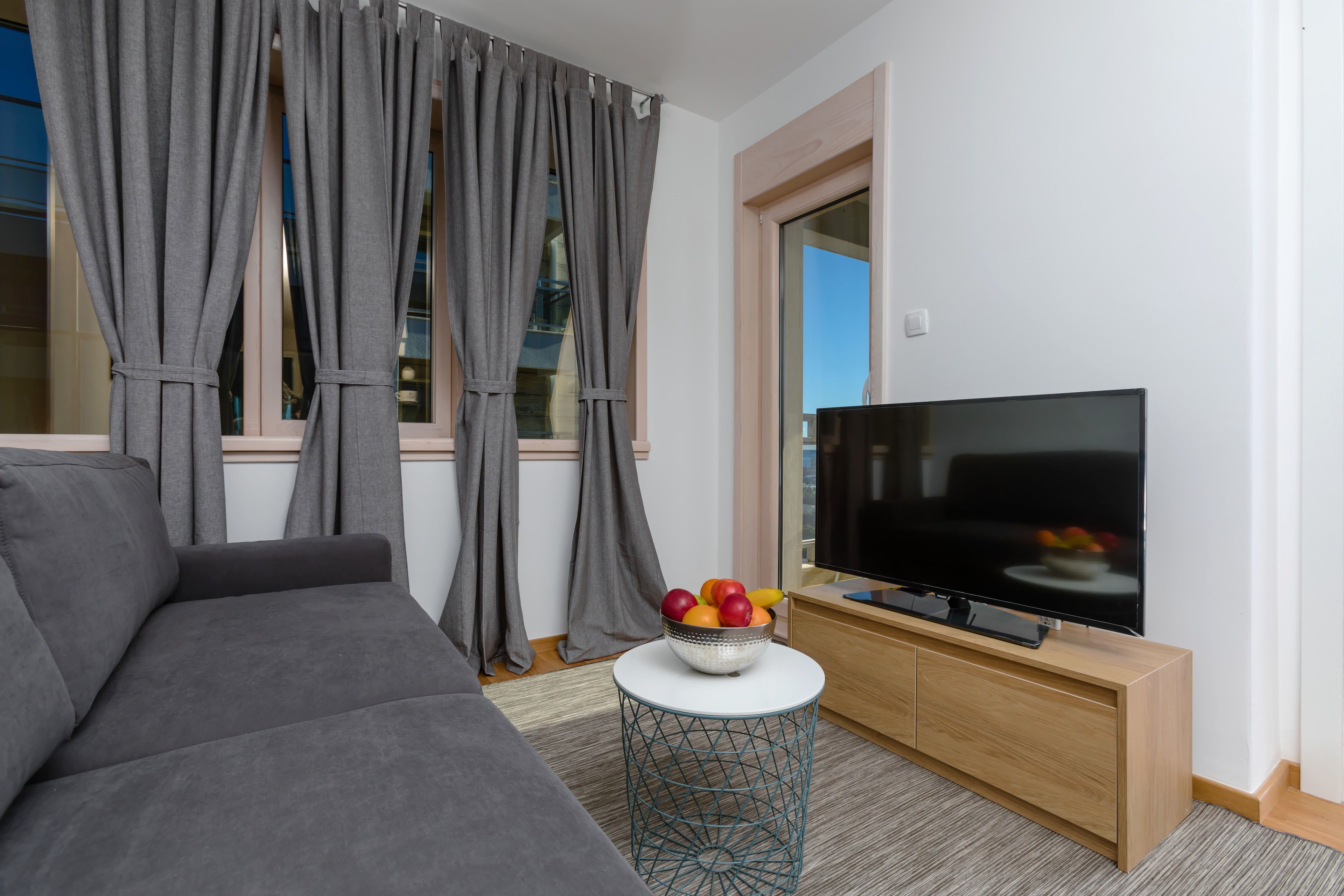 apartment, 1 bedroom, balcony, sea view | living area | flat-screen tv