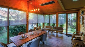 A wooden interior with a dining table, chairs, and a bench. - Chalet Milenium Residence Bran (Bran)
