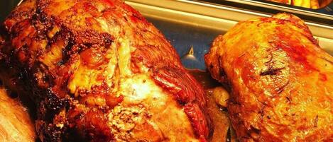 A roasted chicken with crispy skin, served with French fries and rice.