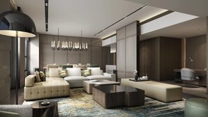 A modern living room with a sofa set, coffee table, and a chandelier.