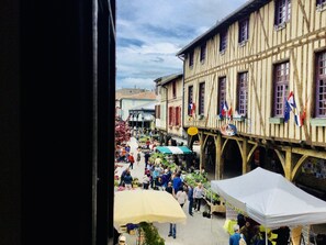 A bustling outdoor market with stalls and people.