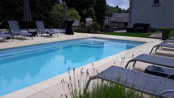 Outdoor pool, open 8:00 AM to 8 PM, pool umbrellas, sun loungers