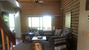 A cozy log cabin interior with a living area featuring a sofa set, a coffee table, and a wooden accent piece. - Cozy Mountain Log Cabin With Amazing Views!  (Pine)