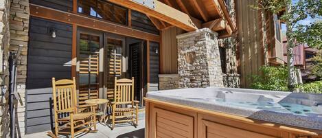 A wooden outdoor seating area with a hot tub.