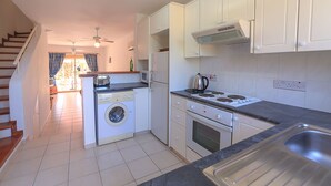 A modern kitchen with a built-in washing machine, oven, microwave, and a gas stove. - Holiday villa with swimming pool near the Paphos coast (Paphos)
