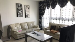 A living room with two sofas, a coffee table, and artwork on the wall. - Time Away From Home (Asse)