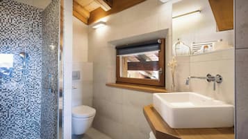 Bathtub, hair dryer, bathrobes, towels