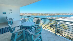 A balcony with a view of a marina and buildings.