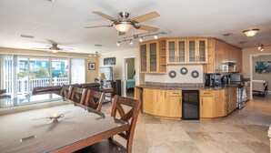 A spacious kitchen with wooden cabinets, a granite countertop, and a built-in oven.