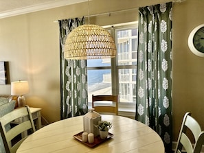 Enjoy a romantic dinner for two at this cozy dining area, complete with a round table and a beautiful view of the sea.