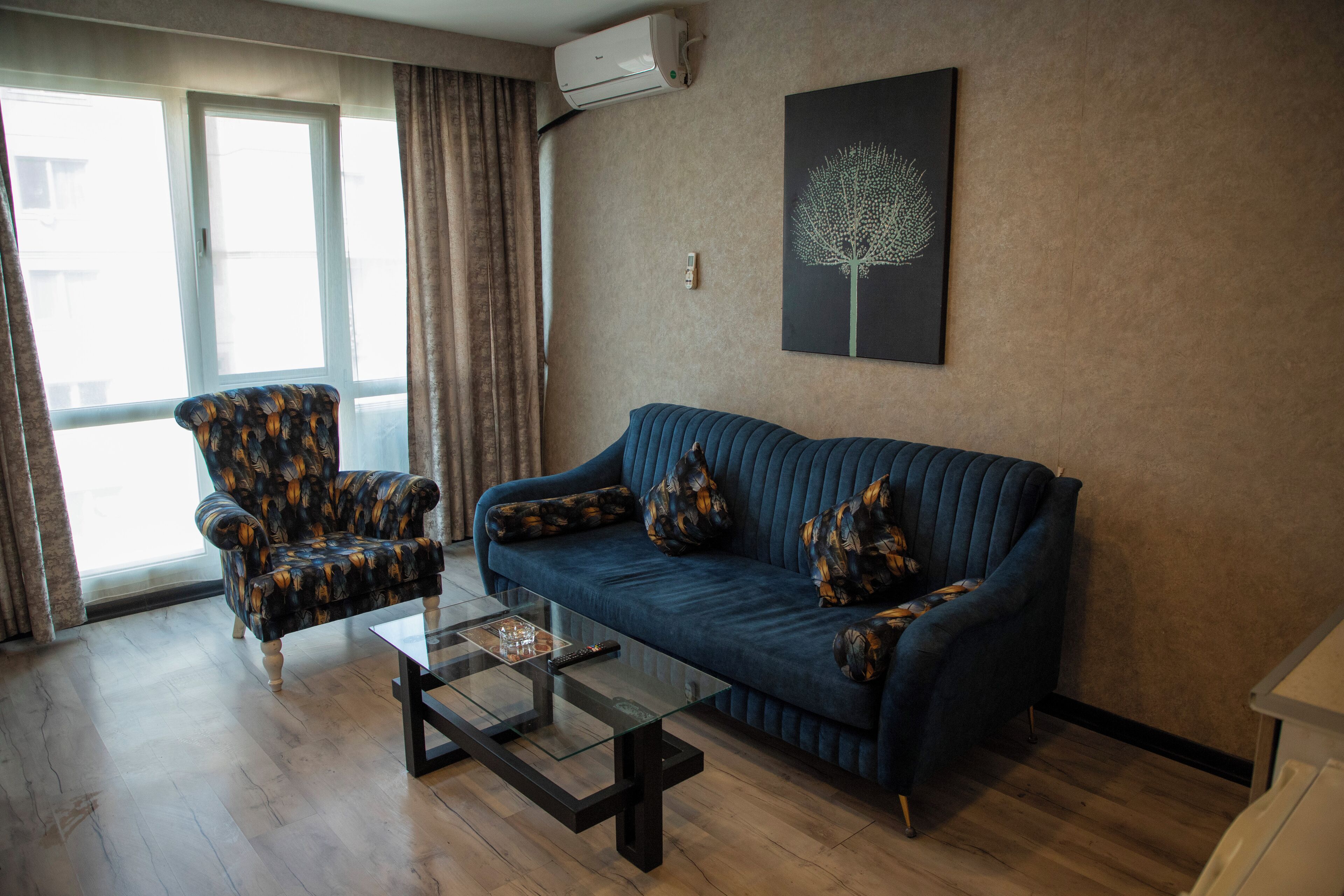 A living room with a sofa, armchair, and coffee table.