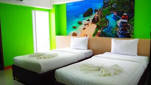 A hotel room with two beds, a green wall, and a large window. - Blue Orchids Hotel (Hat Yai)