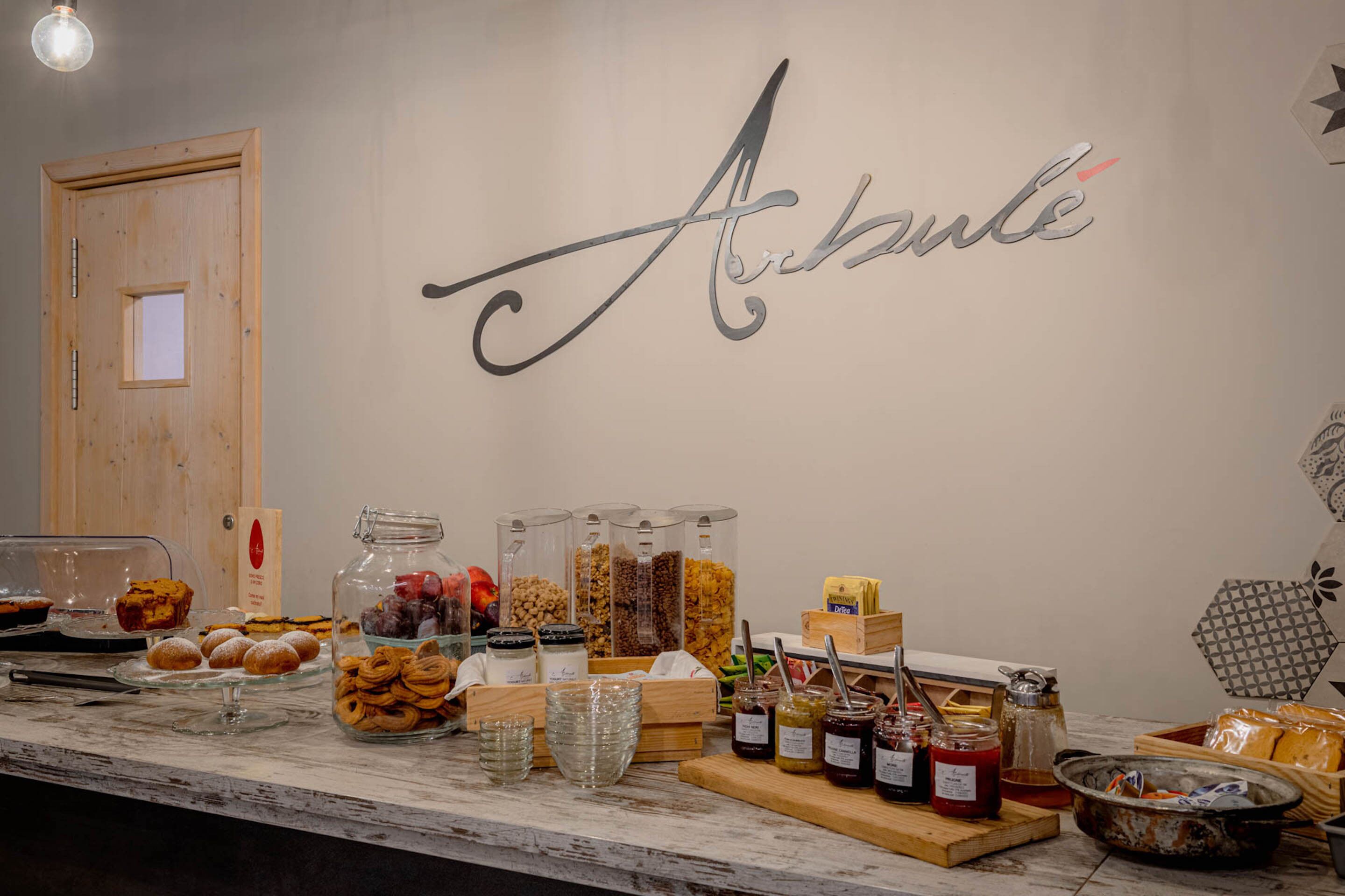 A buffet table with various food items and condiments.