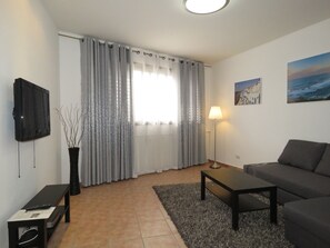 Departamento superior, 1 habitación, vista a la ciudad | Sala de estar | Televisión de pantalla plana 