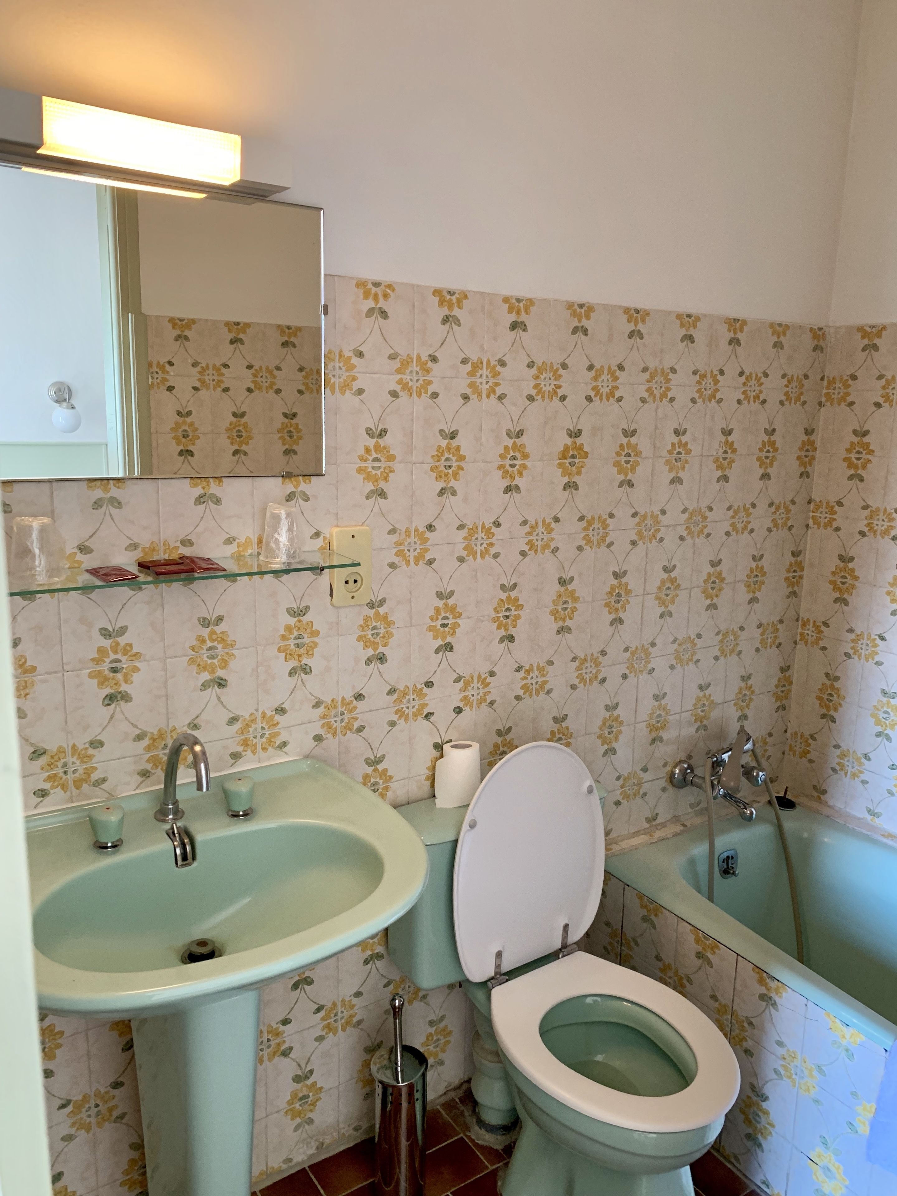 A bathroom with a sink, toilet, and bathtub.