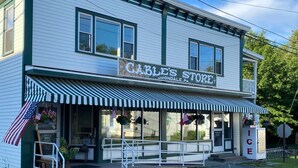 A two-story building with a storefront labeled "Cable's Store." - Cozy Lakefront Getaway (Union Dale)