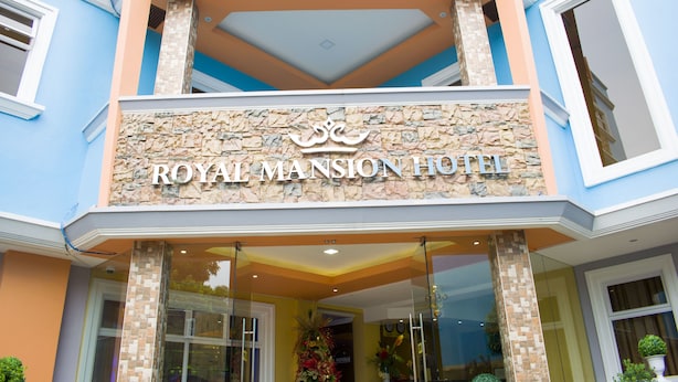The exterior of the Royal Mansion Hotel with a stone facade, a balcony, and a clear entrance. - Royal Mansion Hotel (Tabaco City)