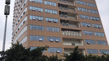 A multi-story hotel with a modern design, featuring numerous windows and balconies.