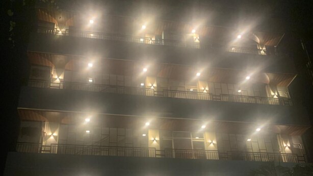 A multi-story hotel with illuminated windows and a sign reading "HOTEL NEW SUNDER". - Hotel New Sunder (Indore)
