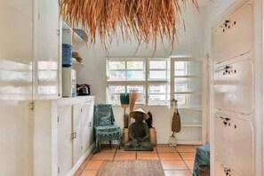 Relax in a serene space with a seating area, meditation statue, and a decorative plant.