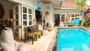 Relax by the pool in an outdoor space with a seating area and covered patio.