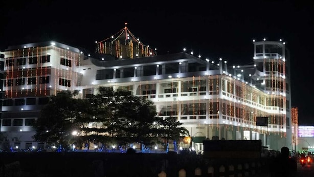 A multi-story hotel with a modern design, featuring balconies and large windows.