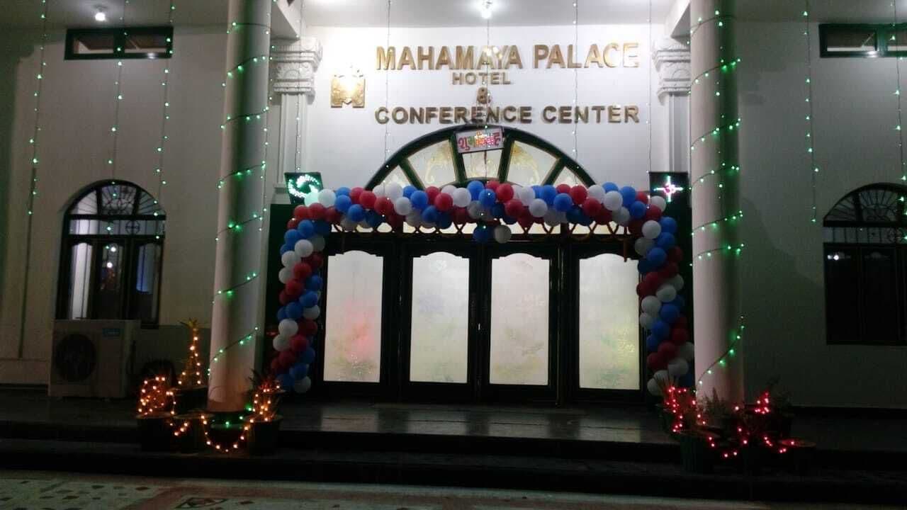 The entrance of Mahamaya Palace Hotel & Conference Center with a decorative arch of balloons and string lights.