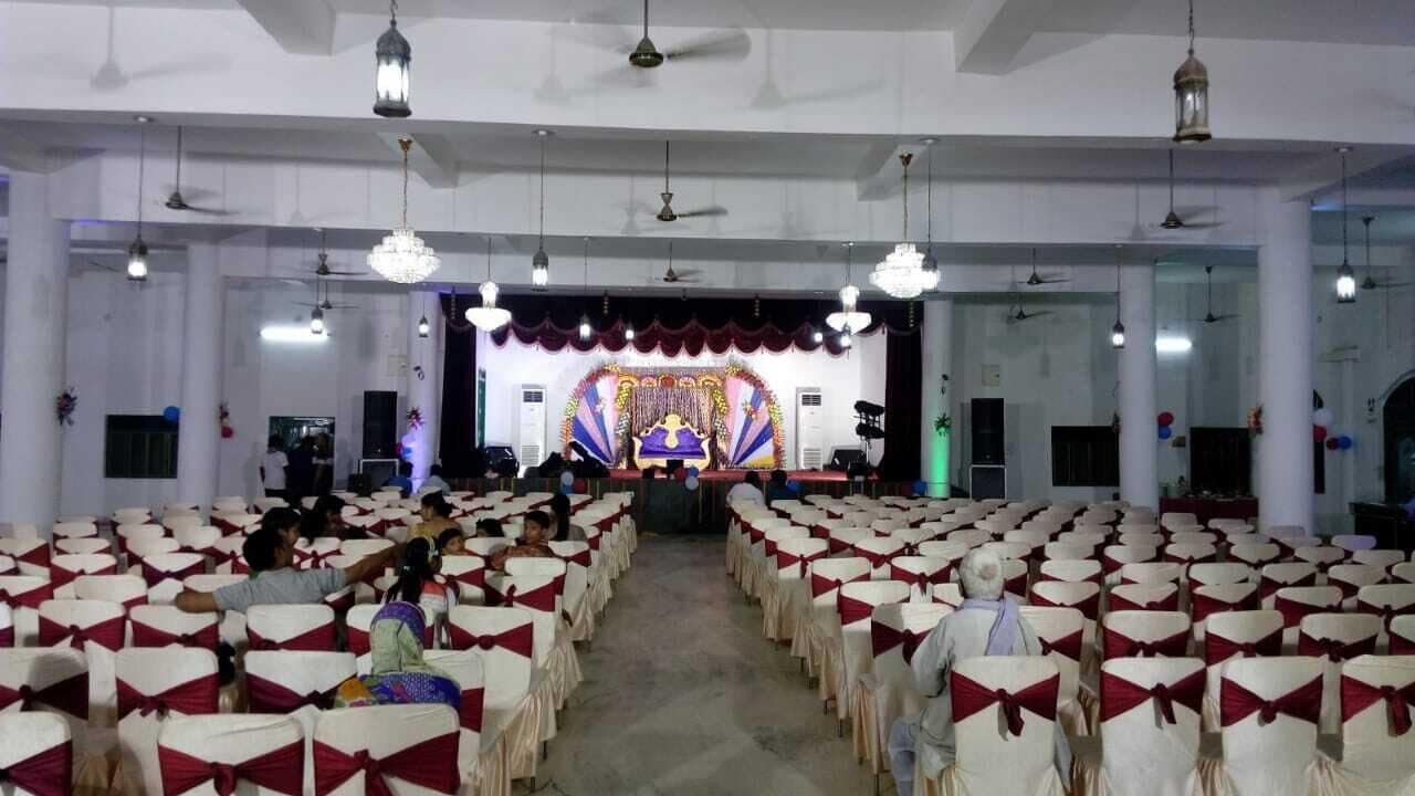A large hall with rows of chairs and a stage at the front.